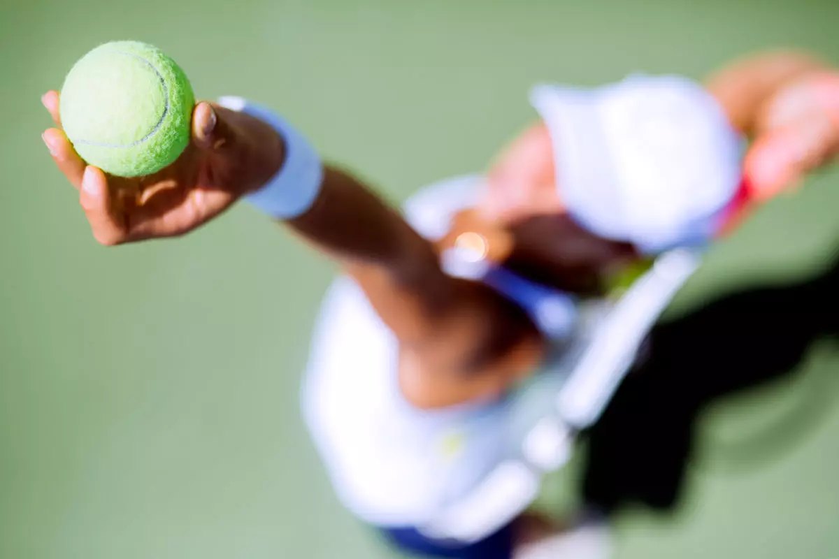 beautiful-female-tennis-player-serving